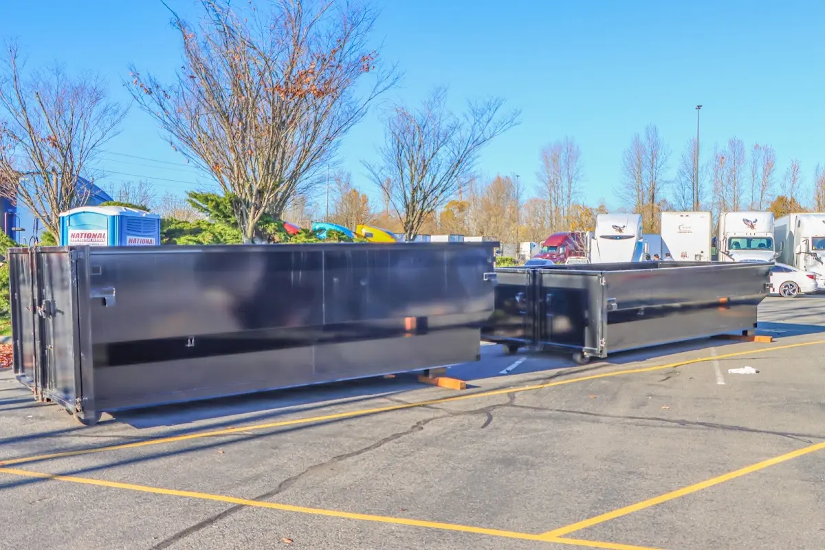 Professional dumpster rental service with roll-off container on residential driveway in Wyckoff